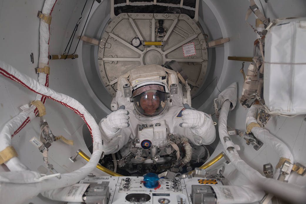 NASA astronaut and Expedition 63 Commander is pictured in his U.S. spacesuit halfway inside the crew lock portion of the Quest airlock during a spacewalk to replace batteries on the International Space Station's Starboard-6 truss structure.