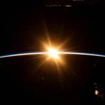 The sun's first rays burst over the Earth's horizon