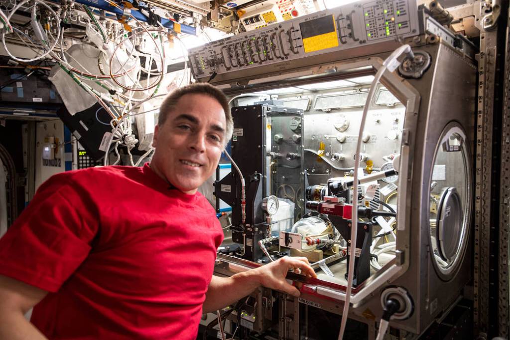 NASA astronaut Chris Cassidy installs fluid research hardware