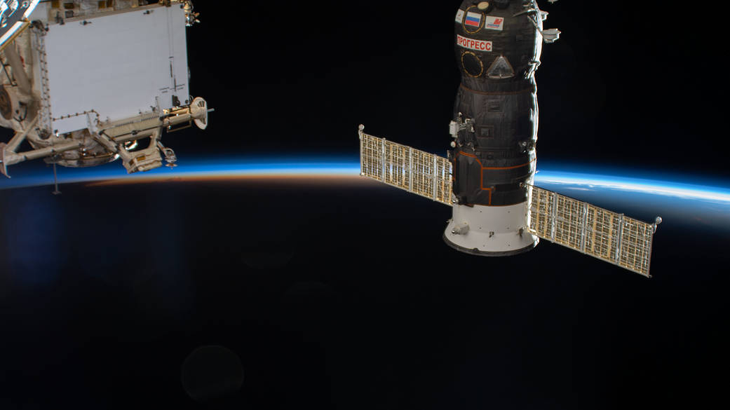 The International Space Station soars into an orbital sunset
