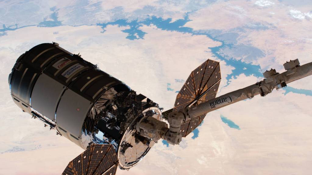 The Cygnus space freighter in the grips of the Canadarm2 robotic arm