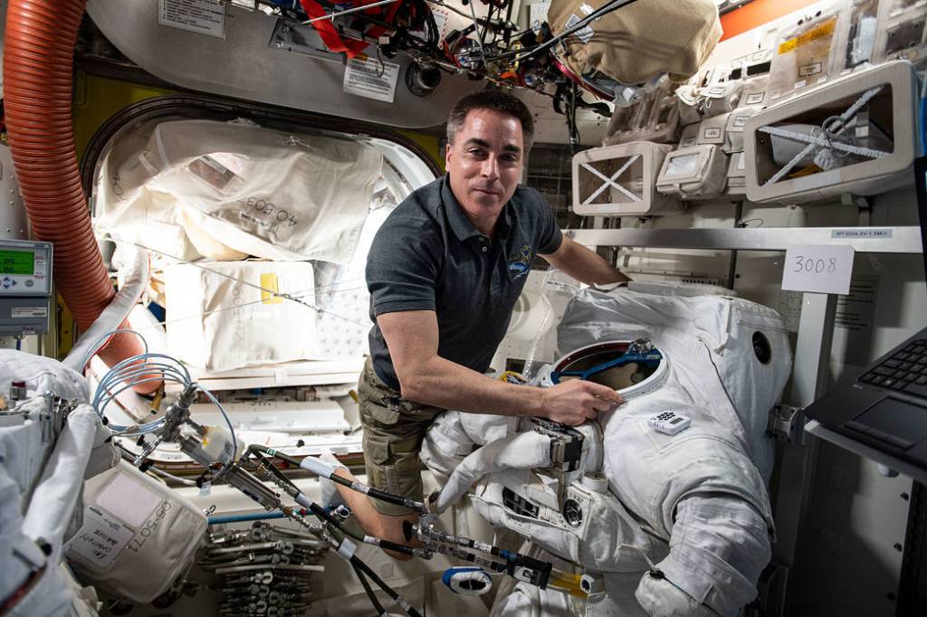 Expedition 63 Commander Chris Cassidy works on a U.S. spacesuit