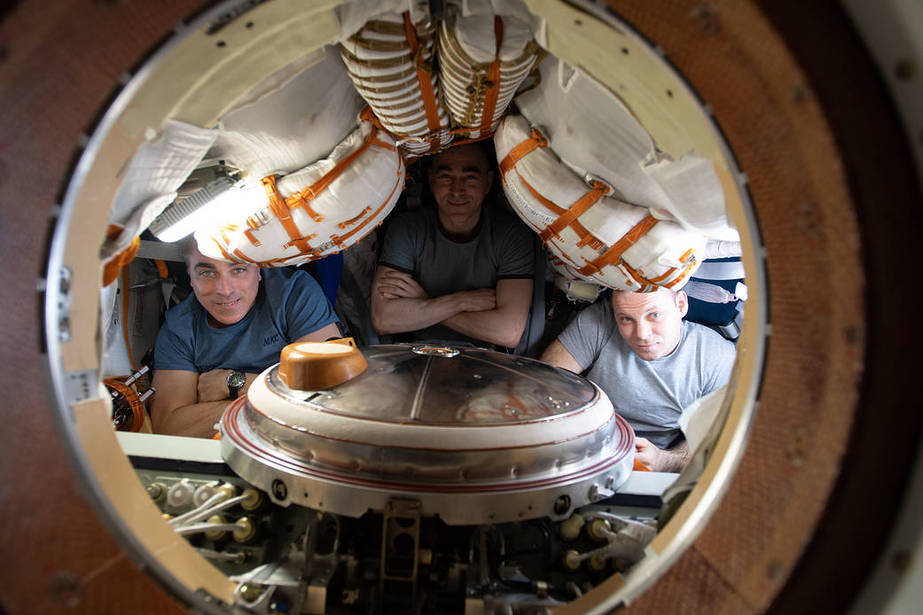 Expedition 63 crewmates seated inside the Soyuz MS-16 crew ship