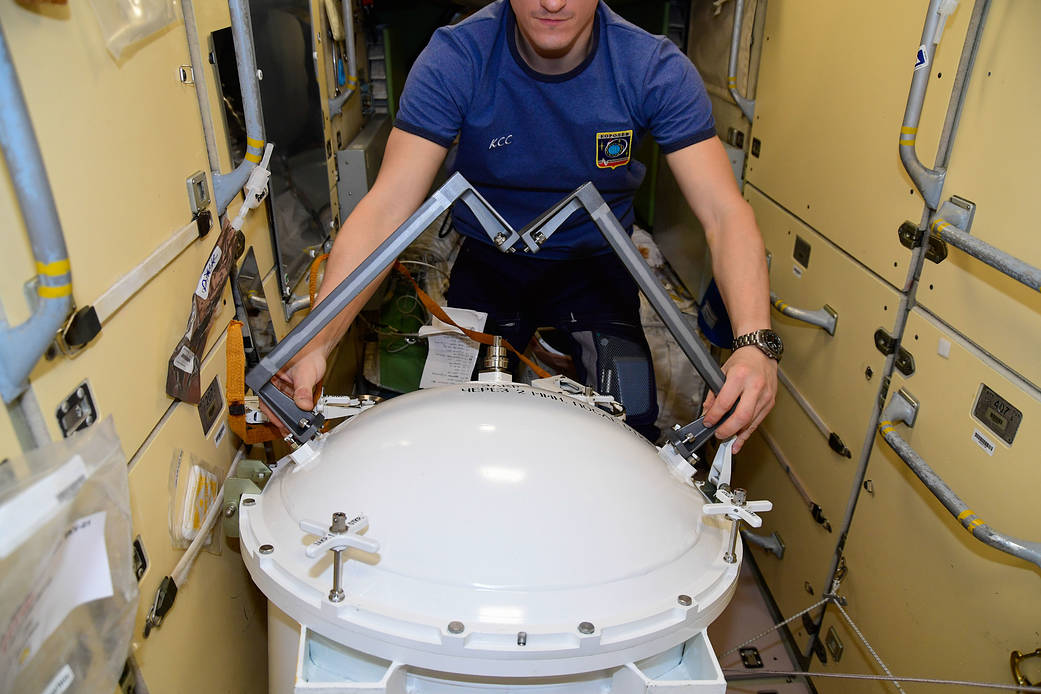 Cosmonaut Sergey Kud-Sverchkov checks out spacewalking hardware