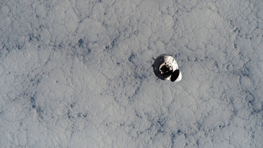 The SpaceX Crew Dragon approaches the space station
