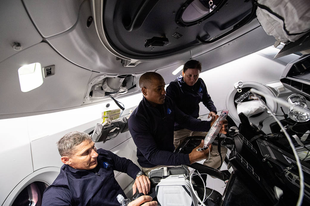 NASA astronauts work aboard the SpaceX Crew Dragon