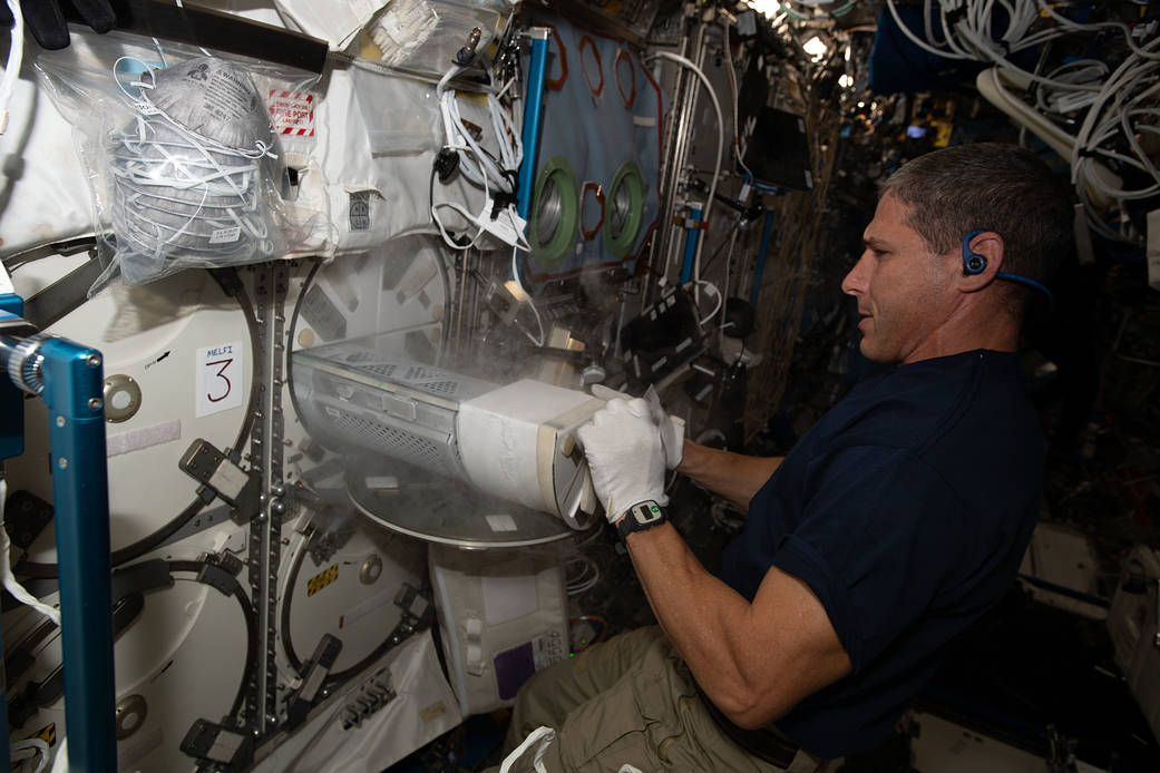 Expedition 64 Flight Engineer Michael Hopkins works on a science freezer