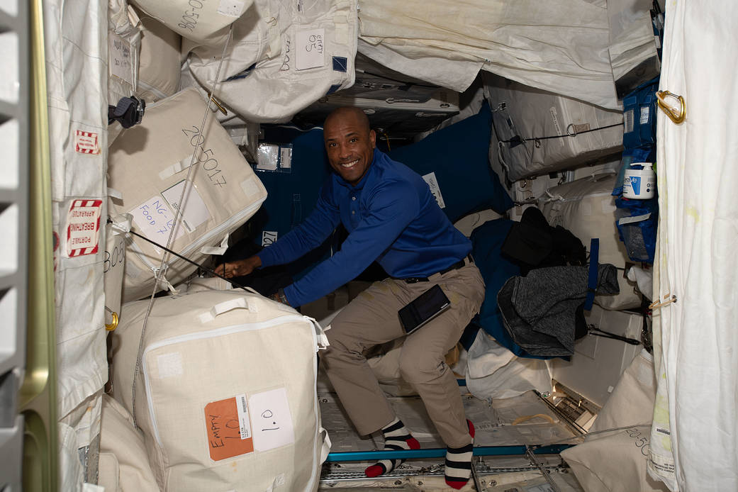 Expedition 64 Flight Engineer Victor Glover among space cargo bags