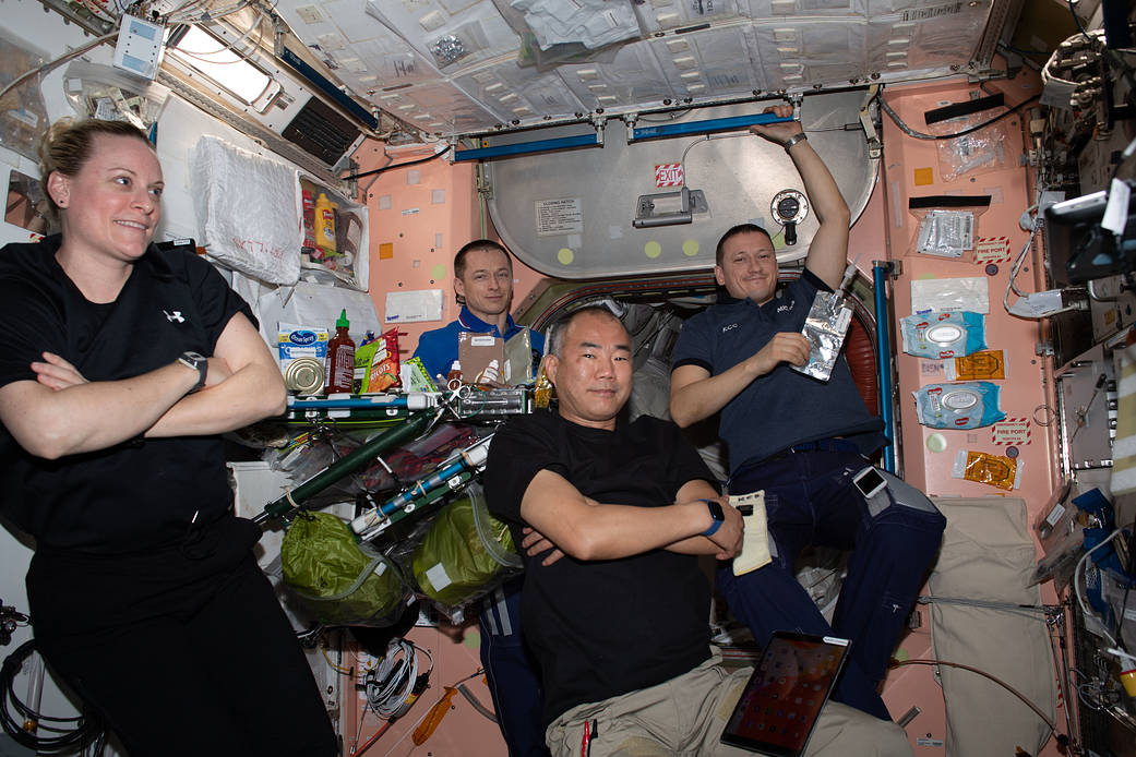 Expedition 64 crew members relax after a meal