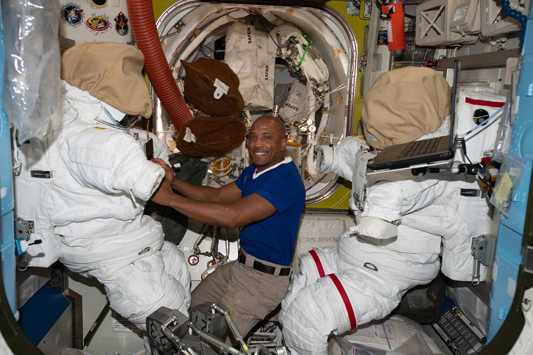 Expedition 64 Flight Engineer Victor Glover works on U.S. spacesuits