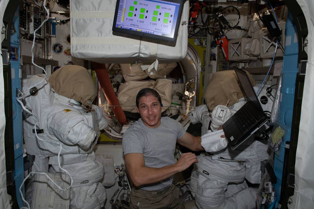 Flight Engineer Michael Hopkins works inside the Quest airlock