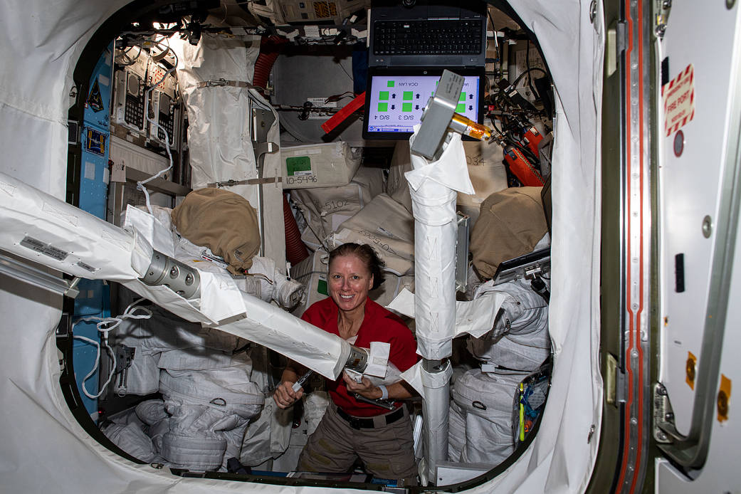 NASA astronaut Shannon Walker works with spacewalk hardware