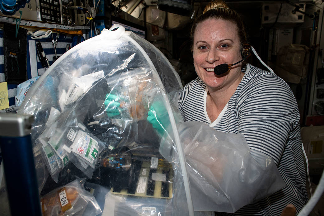 Astronaut Kate Rubins conducts research inside the portable glovebox