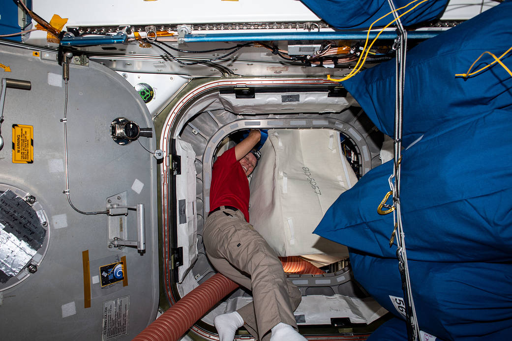 NASA astronaut Shannon Walker packs the Cygnus space freighter
