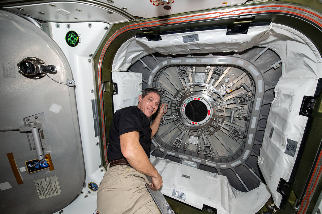 Astronaut Michael Hopkins closes the Cygnus space freighter hatch