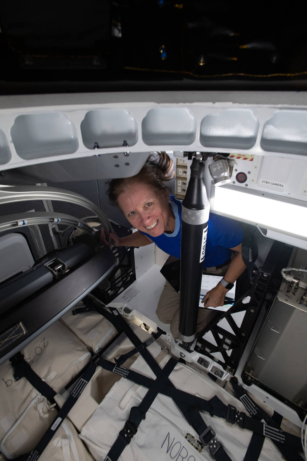 Astronaut Shannon Walker loads cargo inside the SpaceX Cargo Dragon