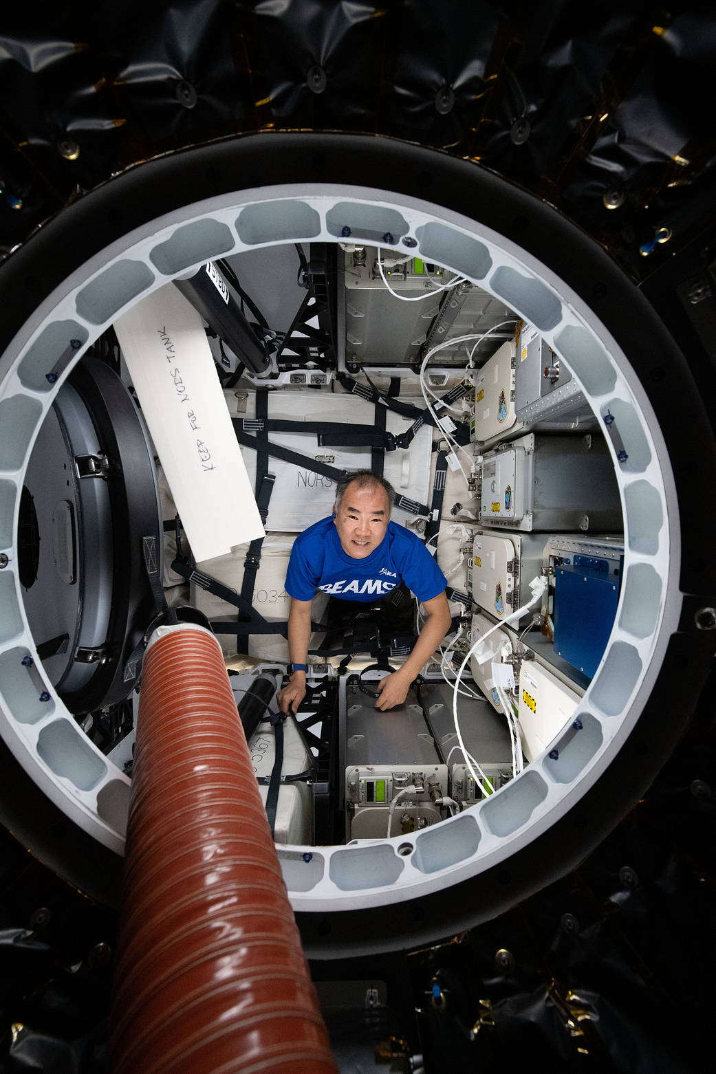 Astronaut Soichi Noguchi loads cargo inside the SpaceX Cargo Dragon