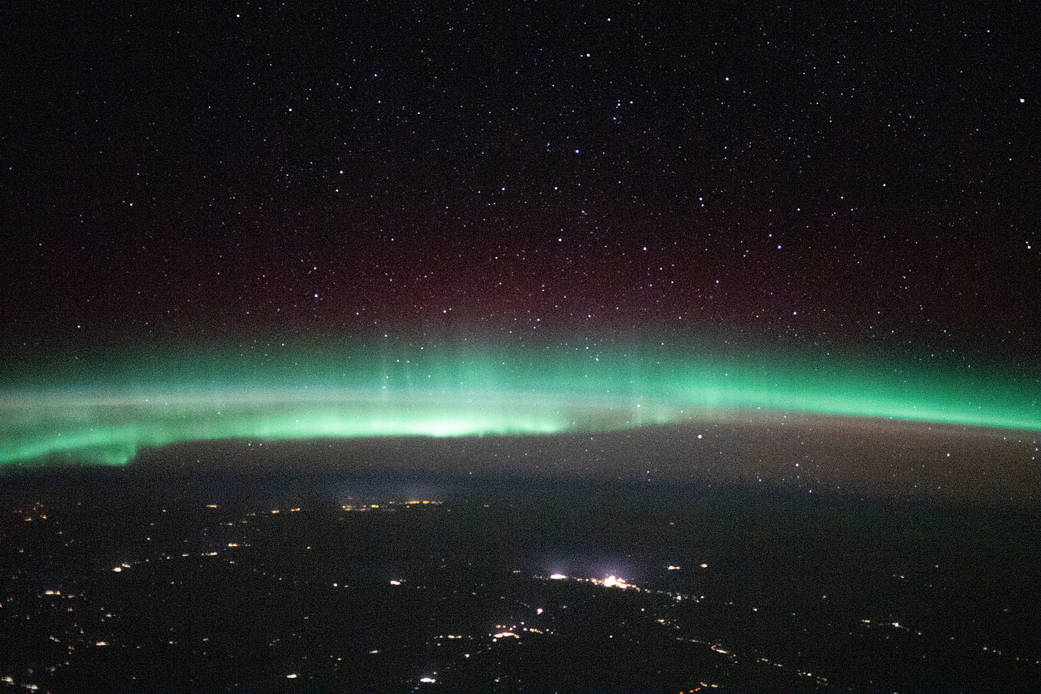 A starry night sky and an aurora above Russia