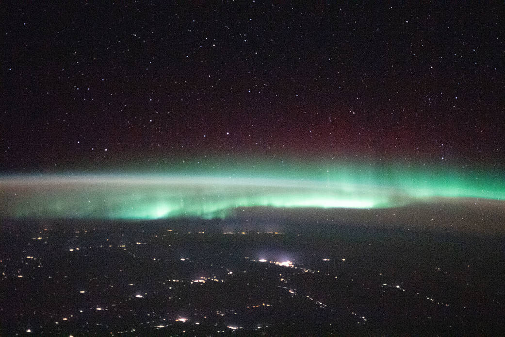 A starry night sky and an aurora above Russia