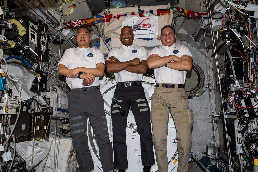 Three Expedition 64 Flight Engineers pose for a portrait