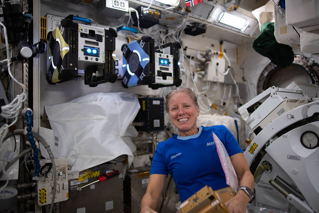 NASA Astronaut Shannon Walker poses with the Astrobee robots