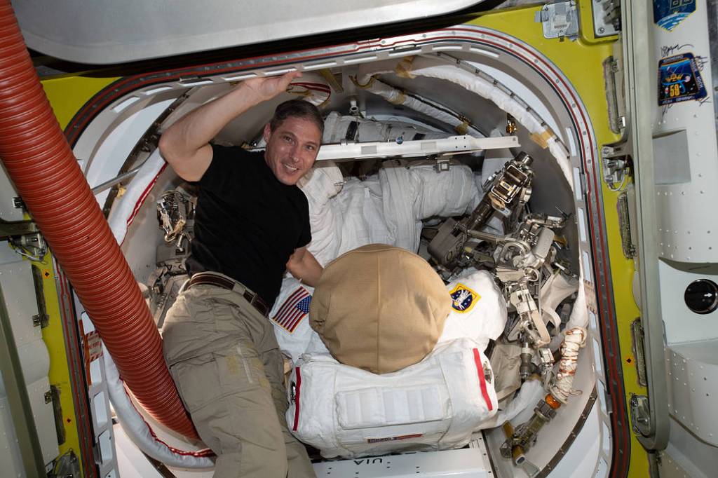 Flight Engineer Michael Hopkins works on U.S. spacesuit maintenance