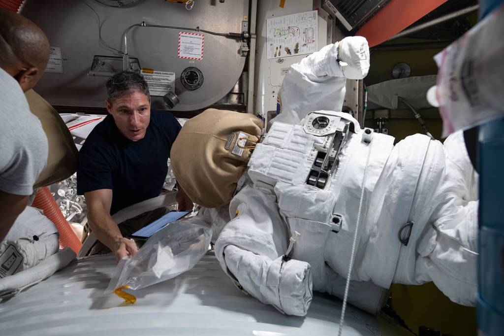 Flight Engineer Michael Hopkins works on U.S. spacesuit maintenance
