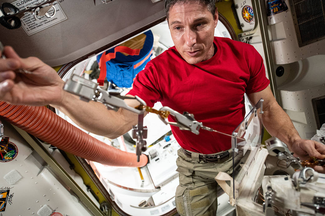 Astronaut Michael Hopkins checks safety tethers