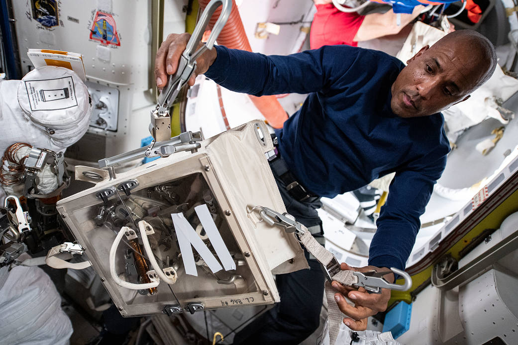 Expedition 64 Flight Engineer Victor Glover works on safety tethers