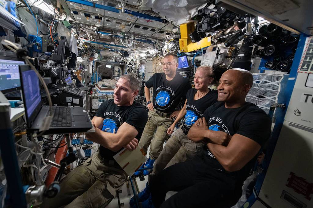 Four Expedition 64 Flight Engineers watch a movie