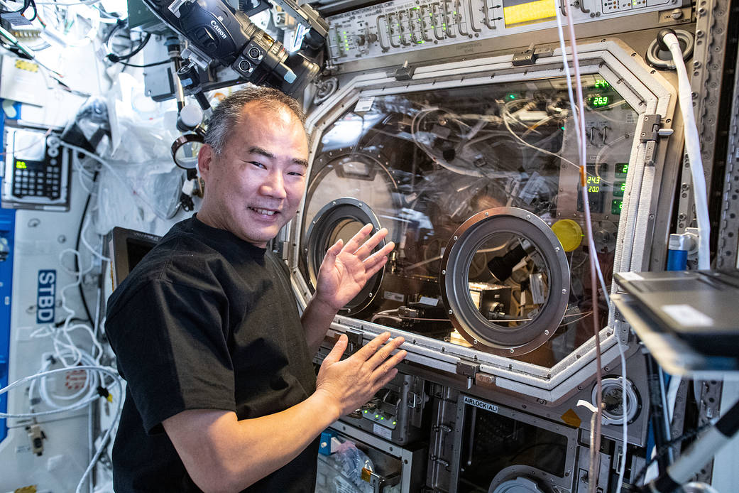 Astronaut Soichi Noguchi shows off the Microgravity Science Glovebox