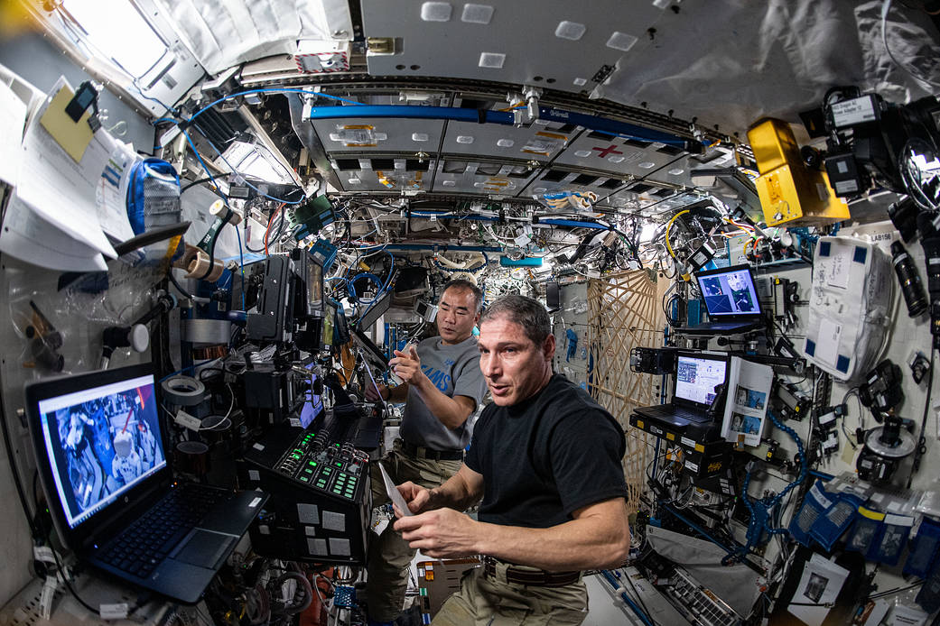 Astronauts Michael Hopkins and Soichi Noguchi practice robotics maneuvers