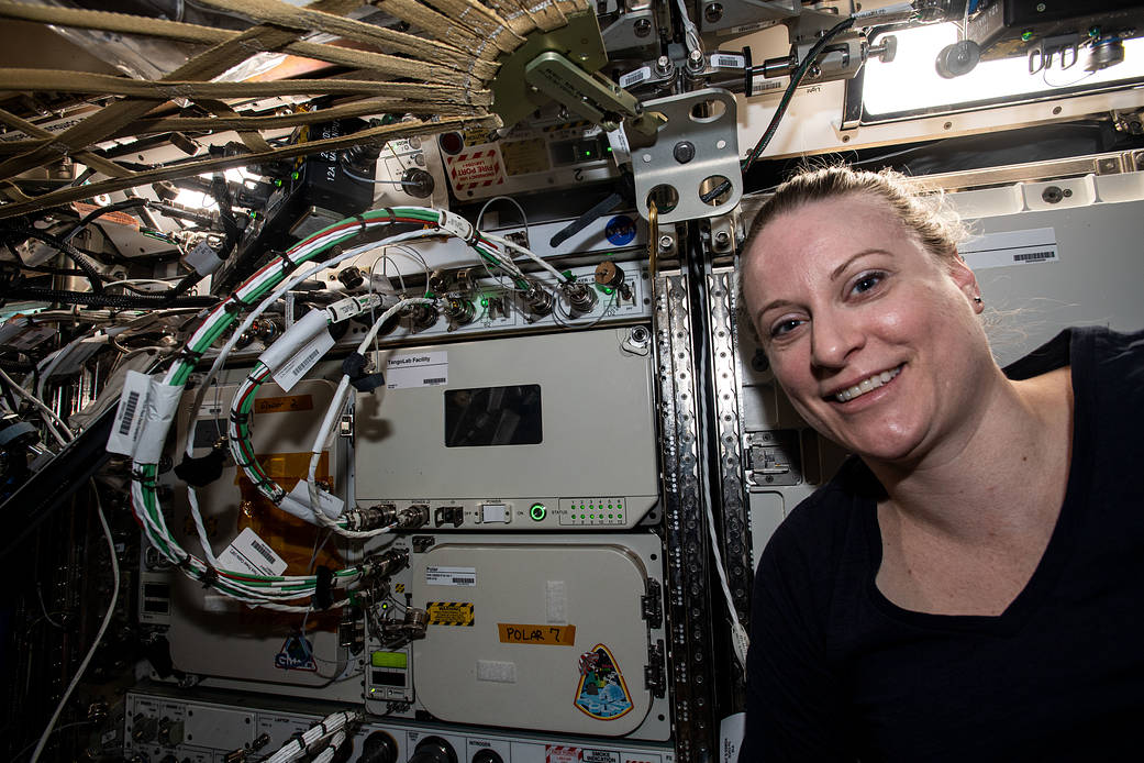 Astronaut Kate Rubins poses next to the TangoLab Facility