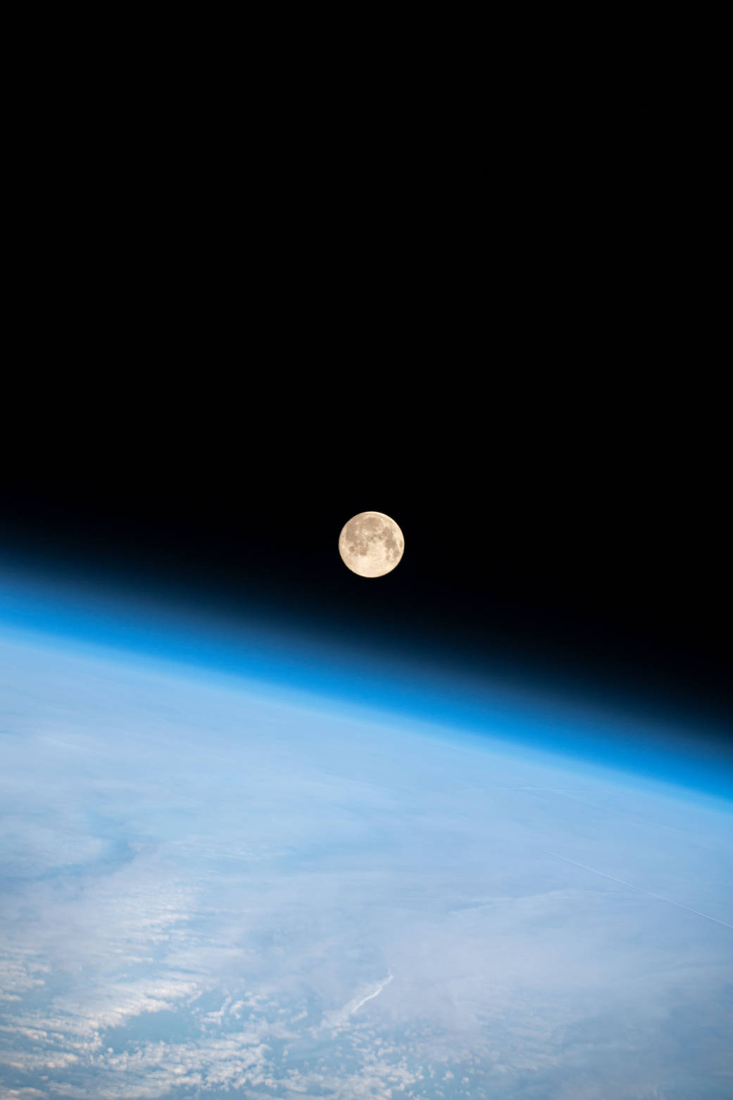 Full Moon above the Earth's horizon