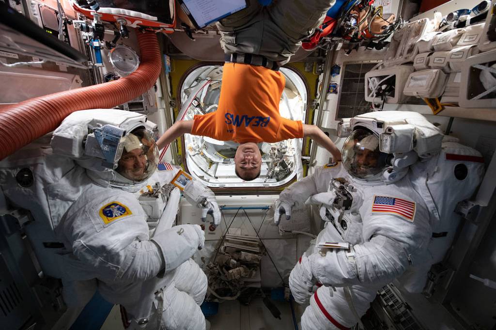 Playful portrait with U.S., Japanese astronauts in Quest airlock