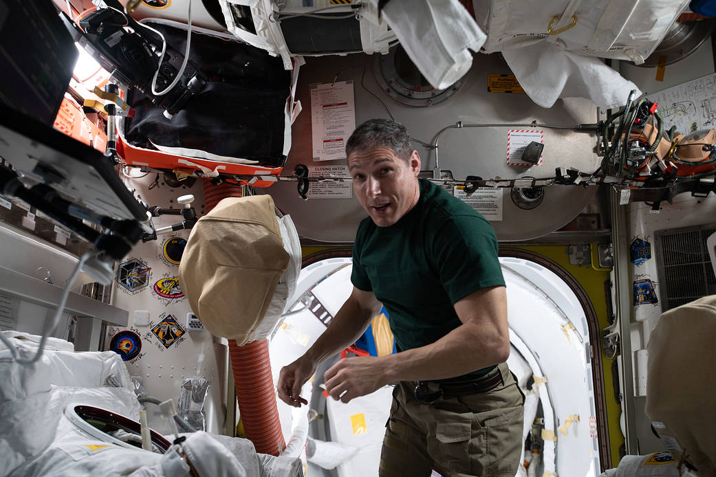 NASA astronaut Michael Hopkins works on U.S. spacesuits