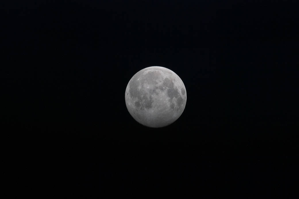 Full Moon above the Earth's horizon