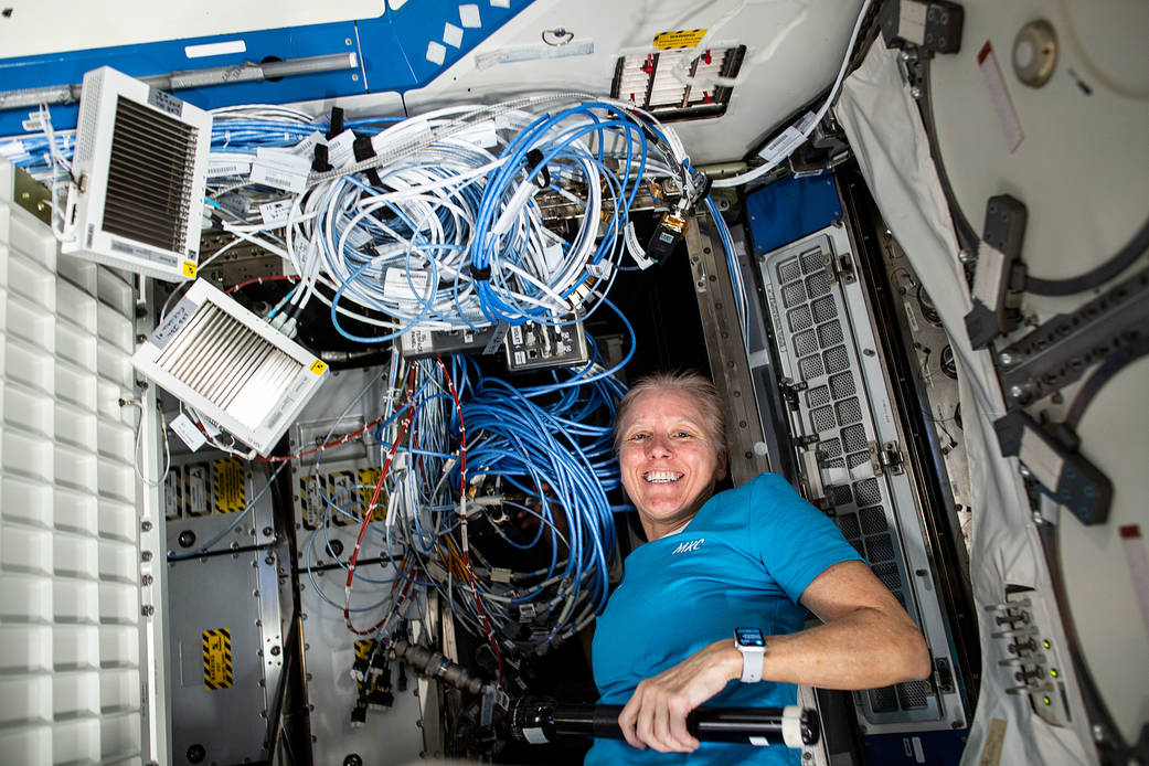 NASA astronaut Shannon Walker connects new ethernet cables