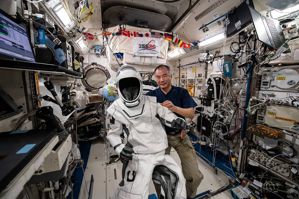 Astronaut Soichi Noguchi shows his SpaceX Crew Dragon spacesuit
