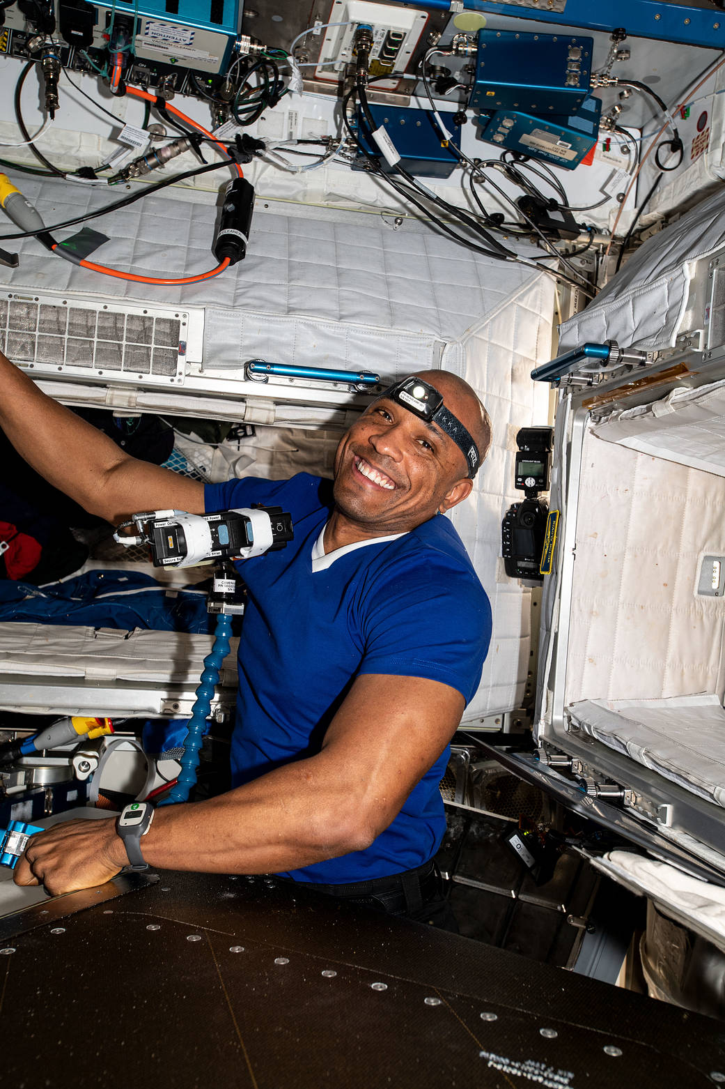 NASA astronaut Victor Glover routes ethernet cables