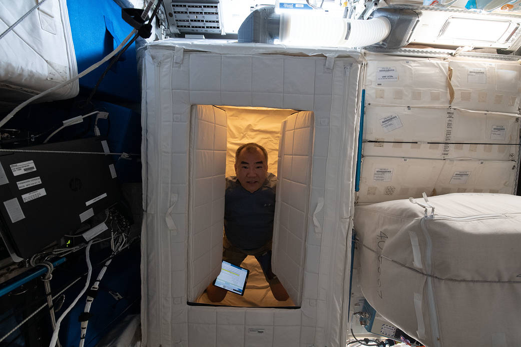 Astronaut Soichi Noguchi is pictured inside a sleep station