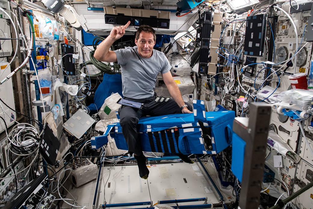 Astronaut Thomas Pesquet sets up experiment hardware