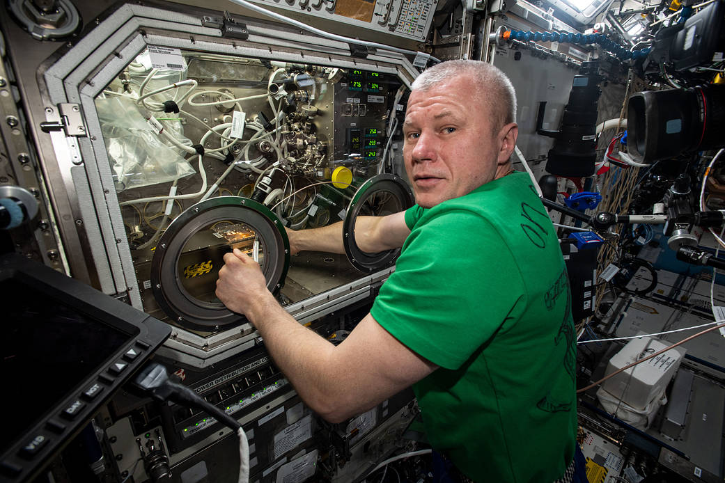 Cosmonaut Oleg Novitskiy swaps hardware for a physics investigation