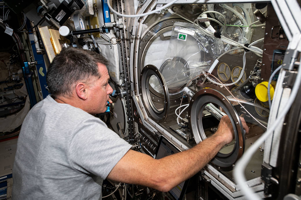 Astronaut Shane Kimbrough works in the Microgravity Science Glovebox