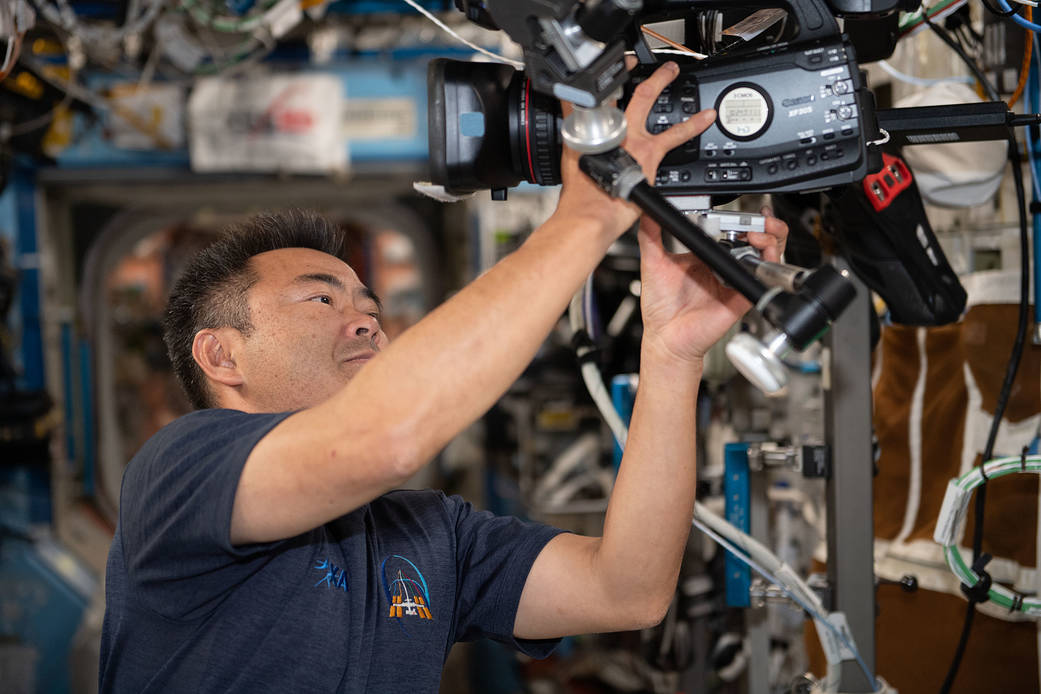 Expedition 65 Commander Akihiko Hoshide sets up a video camera