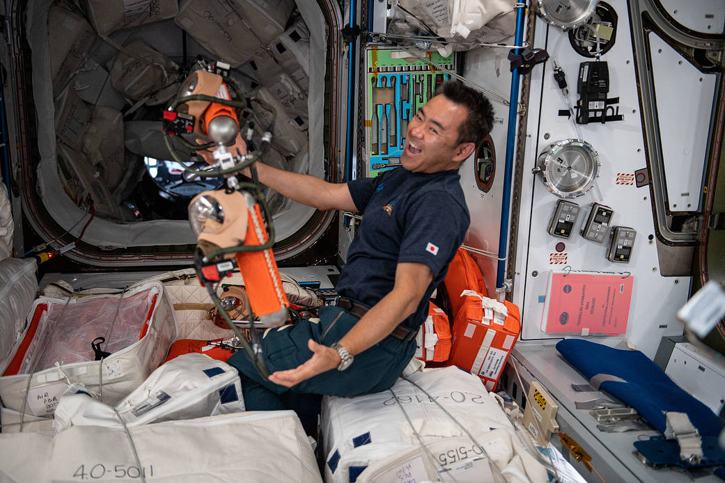 Commander Akihiko Hoshide inspects safety gear