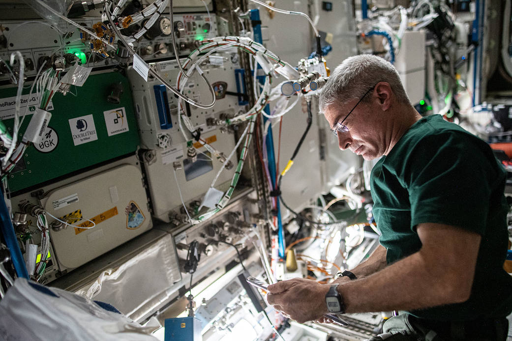 Astronaut Mark Vande Hei works on a space biology research platform