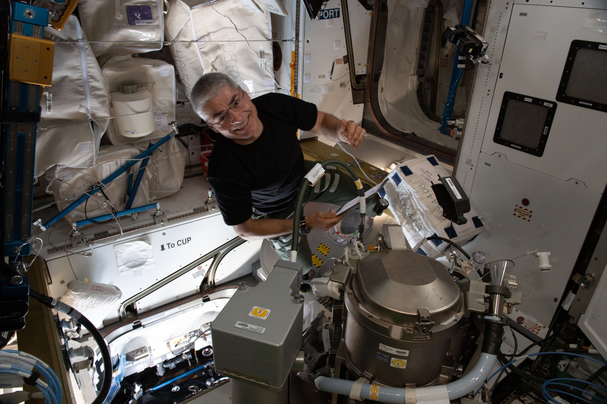 astronaut working on toilet on ISS