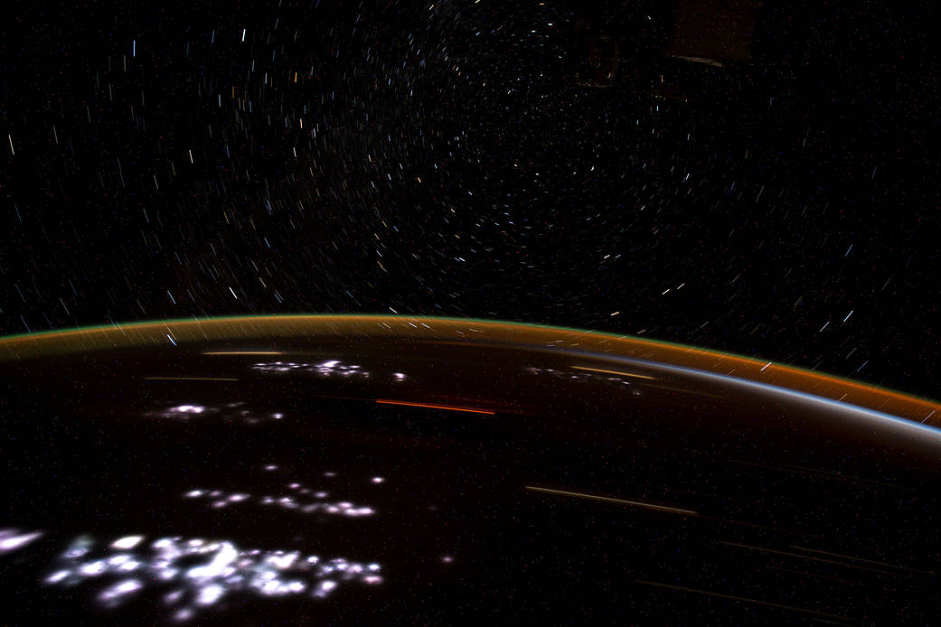 City lights on the African continent, Earth's atmospheric glow and star trails