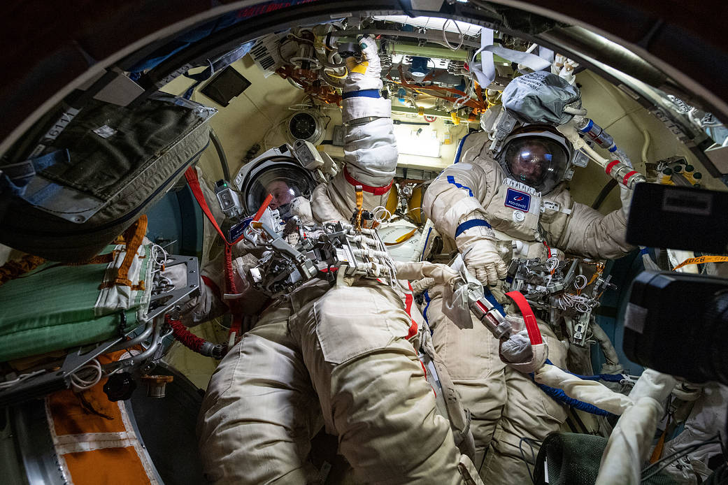 Cosmonauts Oleg Novitskiy and Pyotr Dubrov in their Orlan spacesuits